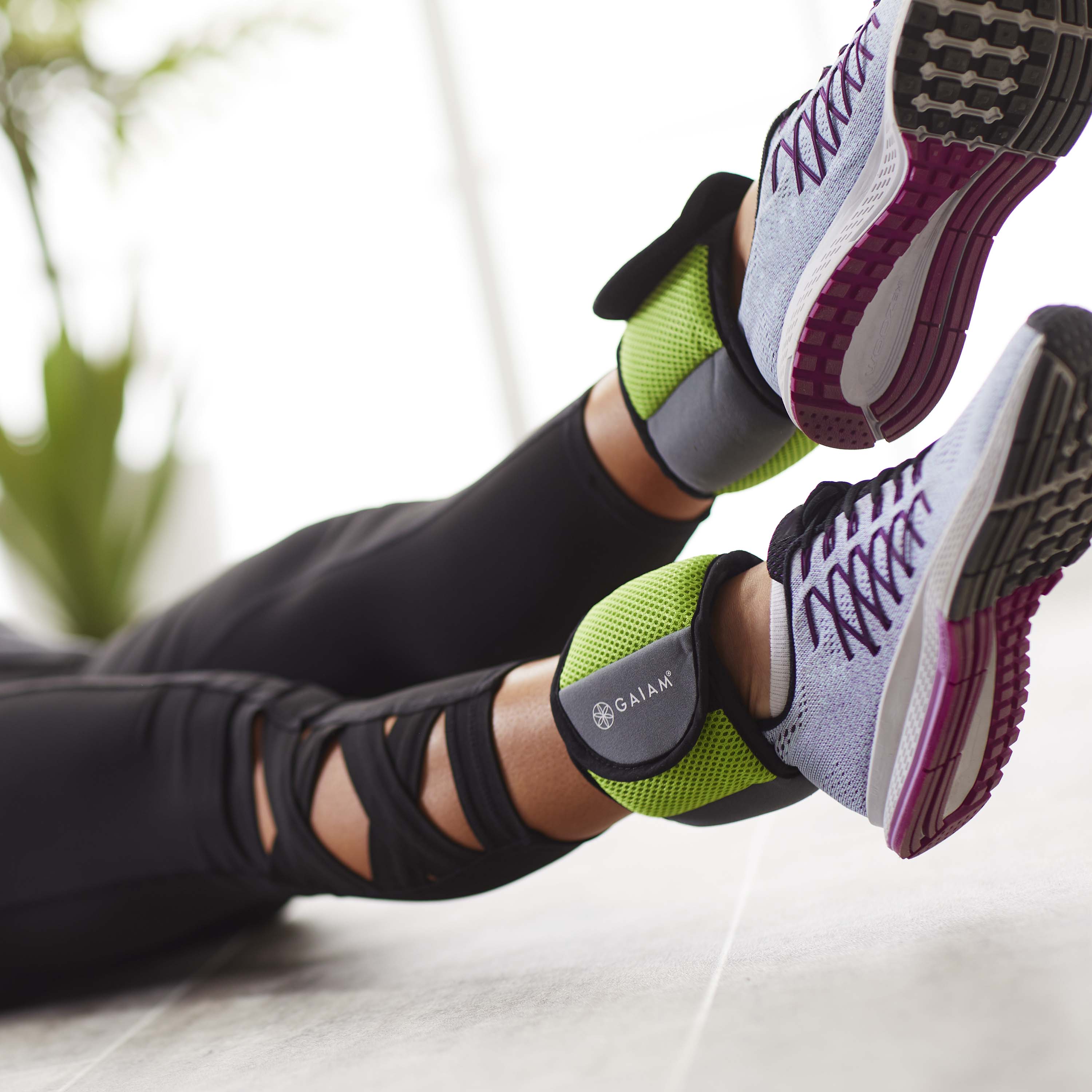 Person with feet in the air wearing the Restore Ankle Weights - up close image